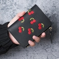Short black litchi leather wallet featuring elegant red cherry embroidery and gold zipper - Black