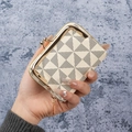 Cream-colored mini wallet featuring black geometric patterns and golden clasp closure - Khaki