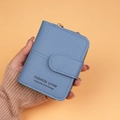 Blue short PU leather wallet with gold side zipper and snap buckle closure held by hand - Blue