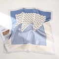 Detailed view of silk square scarf featuring crescent prints and blue geometric patterns - Patchwork Moon Blue