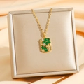 Luxurious gold floral pendant necklace with green crystals on champagne silk background - Green Zirconia