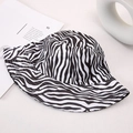 Detailed view of zebra print cotton bucket hat on a minimalist aesthetic background - Black White Zebra
