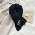 Detailed close-up of a soft black knitted scarf with elegant white letter embroidery - 24*160CM / Black