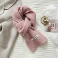 Close-up of a pink wool knit scarf with soft fluffy texture and white vegetable label tag - 20*170cm / Pink