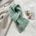 Detail of light green wool scarf with a vegetable label on soft fabric texture - 20*170cm / Tiffany Blue