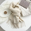 Detail of soft cream cashmere scarf featuring fine fringe and branded woven label - Off-white