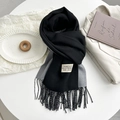 Detail of two-tone black and grey cashmere-like scarf with fringe and brand label - Dark Grey