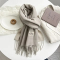 Detail of oat beige cashmere-feel scarf with twill weave, tassels and branded textile label - Khaki Beige