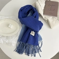 Detail of double-sided blue cashmere scarf with woven label and fringe edges - Klein Blue
