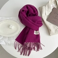 Detail of plum purple cashmere-feel scarf showing soft fringe and woven brand label - Jam Purple