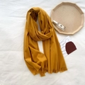 Solid ginger yellow cashmere-feel scarf with short fringe detail on white backdrop - Turmeric