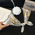 Silk square scarf featuring yellow orchid print on white satin, styled with a camellia pin - 53*53cm / Elegant Orchid Floral