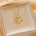 Golden titanium steel necklace with micro-pave zircon flower pendant on jewelry box - Gold Necklace
