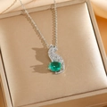Luxury leopard necklace with sparkling zircons and emerald-green gemstone on silk background - Silver Necklace