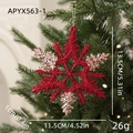 Sparkling red snowflake Christmas ornament with gold glitter details on pine tree - Snowflake Style