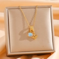 Detail of gold necklace featuring blue opal pendant and sparkling clover charm in a jewelry box - Light Blue Oval And Clover Style (Style 1)