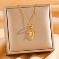 Macro detail of golden Hamsa hand and feather pendant on a stylish titanium steel chain - Hamsa Hand And Feather Style (Style 8)