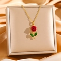 Macro detail of luxury rose pendant with red velvet petals and green leaves on gold chain - Red Rose with Green Leaves