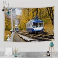 Detail of autumn landscape wall tapestry featuring a blue cable car and European architecture - Blue Alpine Forest Cable Car (Style 11)
