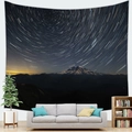Detail view of starry star trail galaxy tapestry hanging above a modern living room sofa - 95x73cm / Star Trails and Snowy Mountain Pattern (Style 14)
