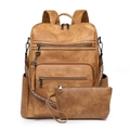 Detail of vintage brown leather backpack with woven ethnic strap and fringe tassel charm - Apricot