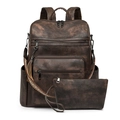 Detailed view of vintage brown leather backpack and pouch set with woven straps - Textured Coffee