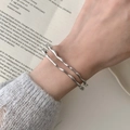 Minimalist silver wavy layered bangle set featuring a polished irregular organic fluid design - Double Layer Twisted Wave Style / Silver