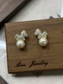 Détail de boucles d'oreilles chiot dorées avec pavé de cristaux et perle blanche - Petit Cheval Perle / Doré