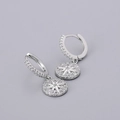 Macro shot of silver starburst hoop earrings with sparkling pavé cubic zirconia details - Round Coin Star Burst Earrings - Silver