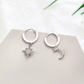 Macro shot of silver S925 moon and star earrings with pavé stones on grey stone base - Hexagram Moon Pave Earrings - Silver