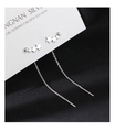 Detailed view of silver star earrings featuring crystal zircon stones and chain tassels - Star Threader Earrings - Silver