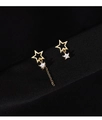 Detailed close-up of asymmetric gold star earrings with sparkling crystals on black fabric - Asymmetric Star Stud Earrings Gold