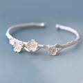 Macro shot of 925 silver plum blossom branch open bangle with golden pistils - White Gold Plated Copper / Plum Blossom Branch Open Bangle (S-B239)