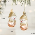Pink mirror-finish snowman ornament with gold glitter accents on a Christmas tree - Snowman Style
