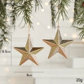 Set of two gold star Christmas ornaments with glitter and stripes on green pine branches - Five-pointed Star