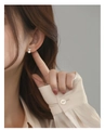Close-up view of elegant S925 silver heart stud earrings with pearls on model - Silver Heart Pearl Style