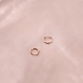Rose gold Mobius twist earrings in S925 sterling silver on pink silk background - Twisted Hoop / Rose Gold
