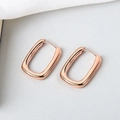 Macro detail of rose gold U-shaped earrings showing polished finish and S925 stamp - Rose Gold