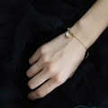 Elegant gold chain bracelet with heart shell pendant and beads on wrist against dark tulle - Heart Shell Bracelet (Gold Color)