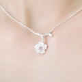 Delicate silver cherry blossom necklace with pink gemstone and curved branch detail - Pink Sakura Necklace