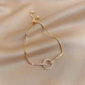 Detail of gold adjustable box chain bracelet with sparkling zircon interlocking rings - Asymmetric Pave Circles Style