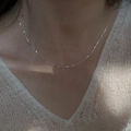 Minimalist S925 sterling silver beaded choker necklace shown on neck with white sweater - XL1136