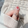 Detail of adjustable silver ring featuring a crystal letter J and a round zircon stone - Letter J