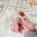 Detail of silver letter L ring with cubic zirconia and round gemstone on model finger - Letter L