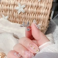 Macro shot of silver letter M ring with cubic zirconia on woman's finger - Letter M