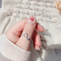 Detail of adjustable silver ring with zircon inlay and offset square diamond design - Letter O