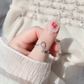 Detailed view of adjustable silver ring featuring letter Q with zircon and pavé crystals - Letter Q