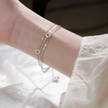 Close-up of three-layer 925 silver bracelet featuring circular rings and heart charm - Triple Layer Circle Bracelet