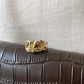 Macro shot of gold minimalist ring with irregular lava texture on brown leather - Concave-Convex Wrinkled Lava Texture Style (R1047)