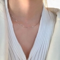 Close-up of a sleek S925 sterling silver snake chain necklace on a model's neck - Round Snake Chain